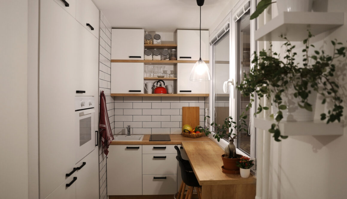White kitchen with red components, cosy tine house